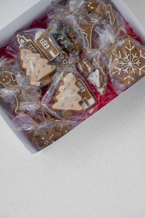 Free Assorted Christmas-themed gingerbread cookies in a decorative box, perfect for holiday celebrations. Stock Photo