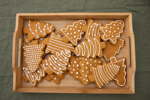 Free Brown Christmas Tree-Shaped Gingerbread Cookies in a Wooden Crate Stock Photo