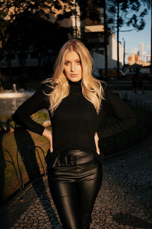 Free Pretty Woman in Black Long Sleeve Shirt and Black Leather Pants Looking at Camera Stock Photo