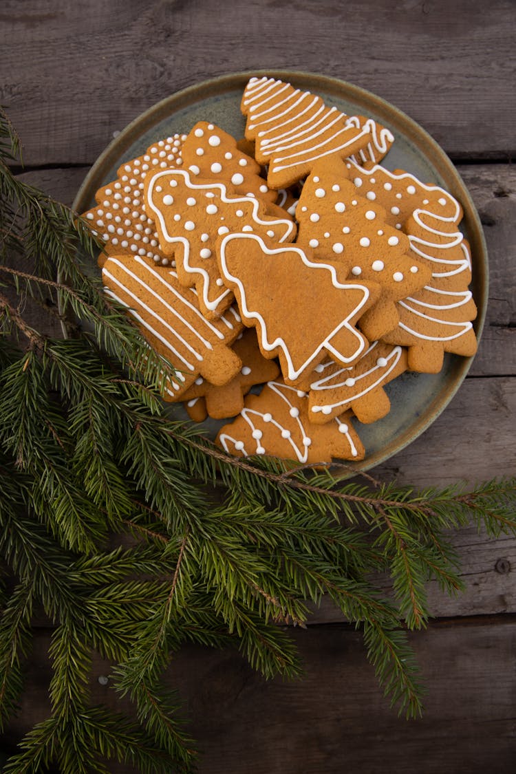 Brown Christmas Tree-Shaped Gingerbread Cookies Near Fir Leaves