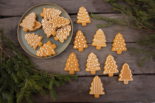 Brown Christmas Tree-Shaped Gingerbread Cookies on Wood Background