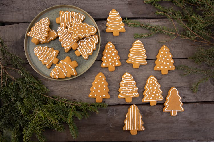 Brown Christmas Tree-Shaped Gingerbread Cookies On Wood Background