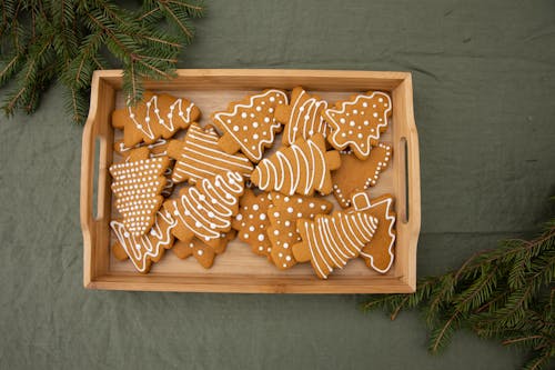 Free Brown Christmas Tree-Shaped Gingerbread Cookies in a Wooden Crate Stock Photo
