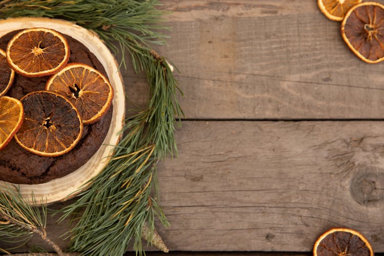 Chocolate Christmas Cake Wit Oranges On Wooden Background