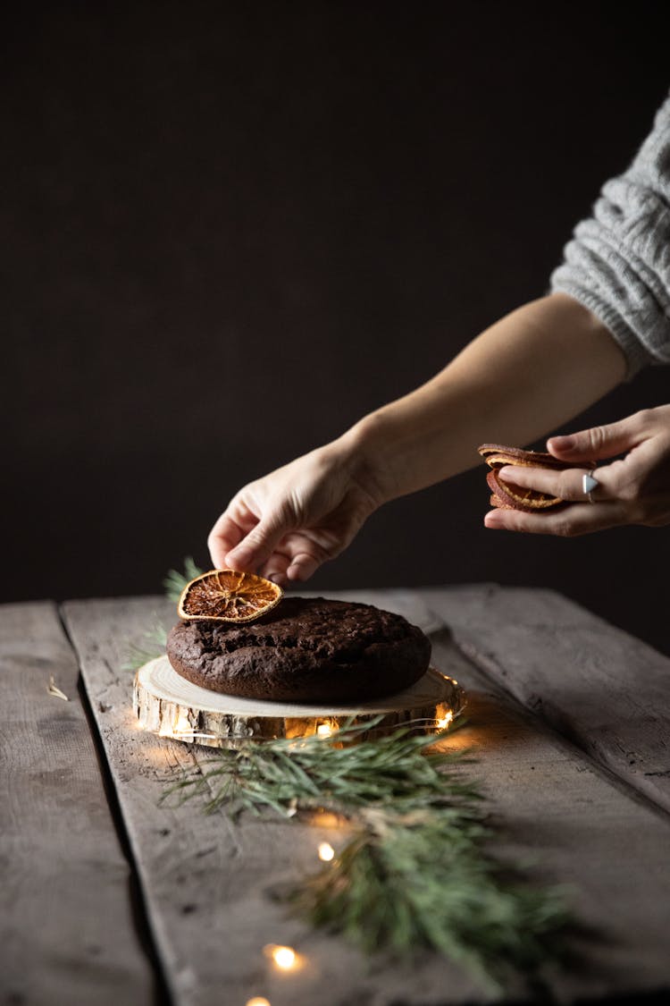 Woman Decorating A Cake For Christmas