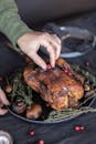 Person Holding a Roasted Turkey