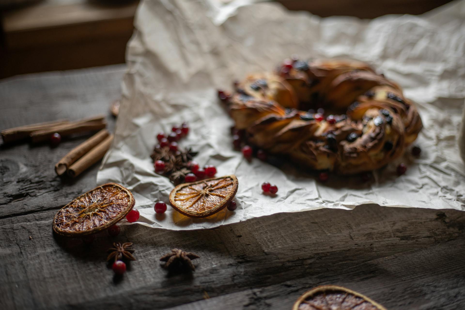 Bread on Baking Paper Beside Orange Slices