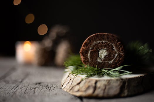 A close-up of a chocolate cake roll on a rustic wooden tray, perfect for dessert lovers.