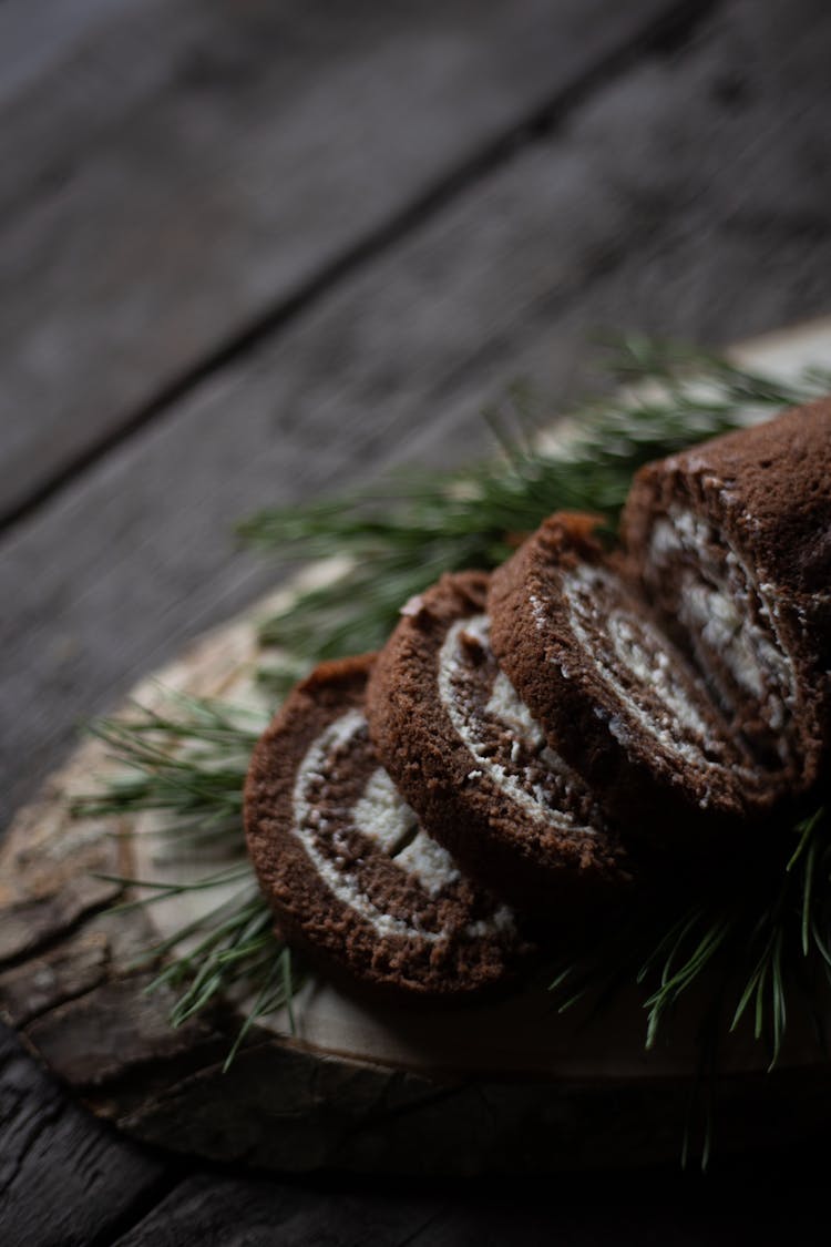 Slices Of Cake Rolls On Wooden Plank