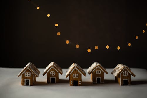 Gingerbread Houses Lined up on White Surface