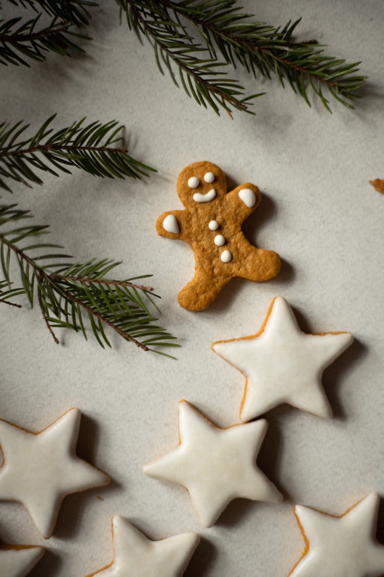 Gingerbread Man Beside Star Cookies