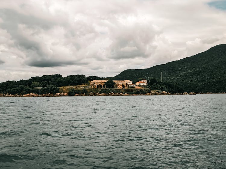 Villa On An Island Beach Resort Near Mountain Under Cloudy Sky