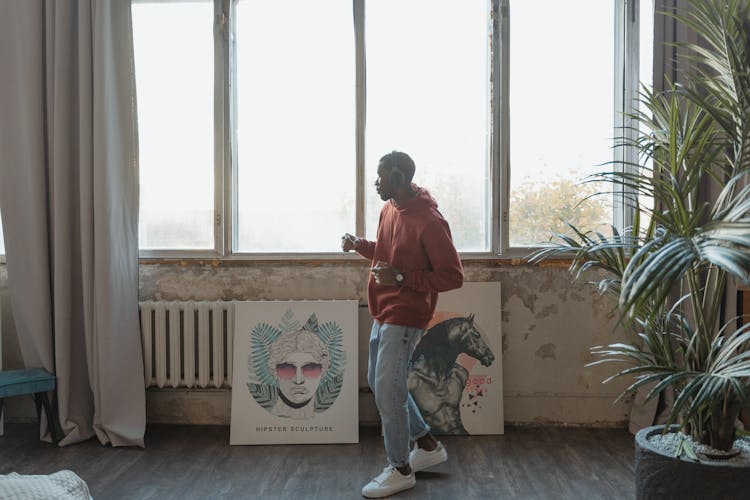 Man In Red Hoody Dancing Near The Window 