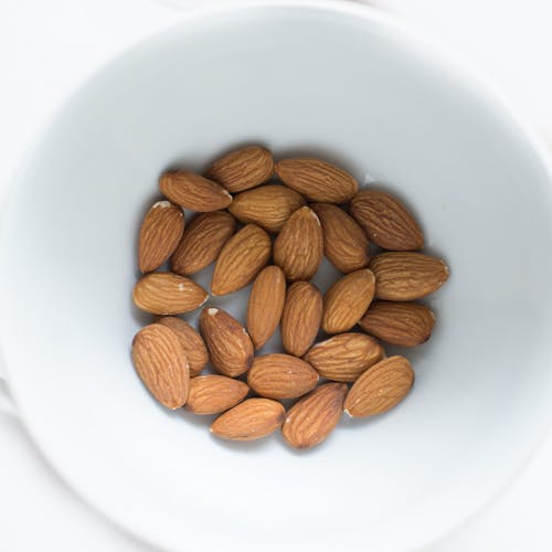 Brown Almond Nuts on White Ceramic Bowl
