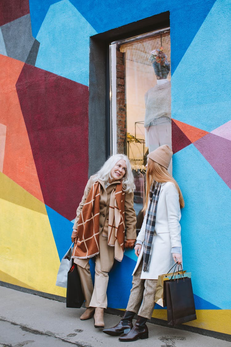 Women Leaning On The Colorful Wall