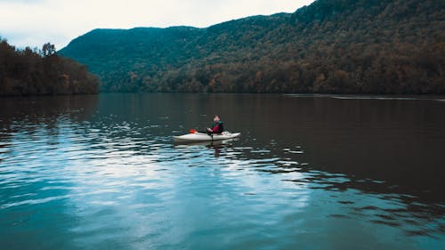 Man Sitting on a Kayak on the Lake