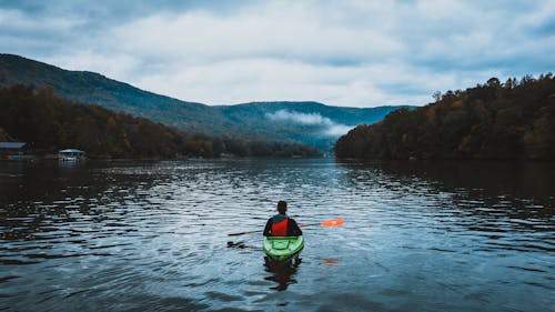 Free Man Kayaking on the Lake Stock Photo