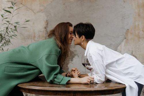 Free Loving couple sharing an intimate moment with wine indoors. Stock Photo