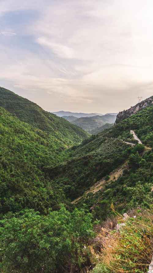 Free Beautiful view of a lush green mountain valley under a serene sky. Stock Photo