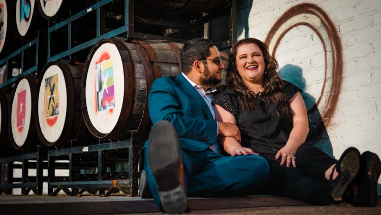 Man In Blue Suit Sitting On The Floor Beside A Woman