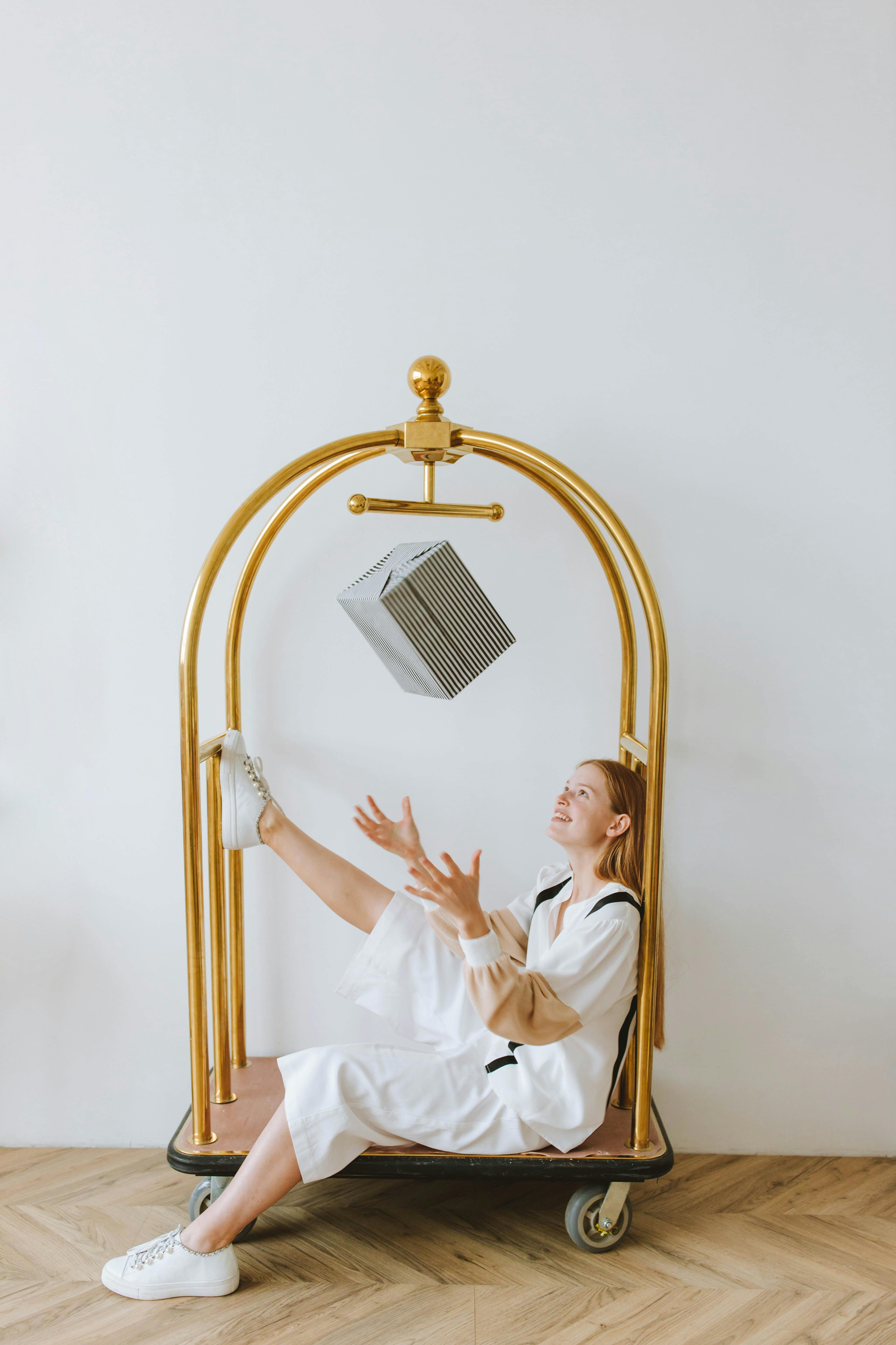 a woman sitting on a luggage cart