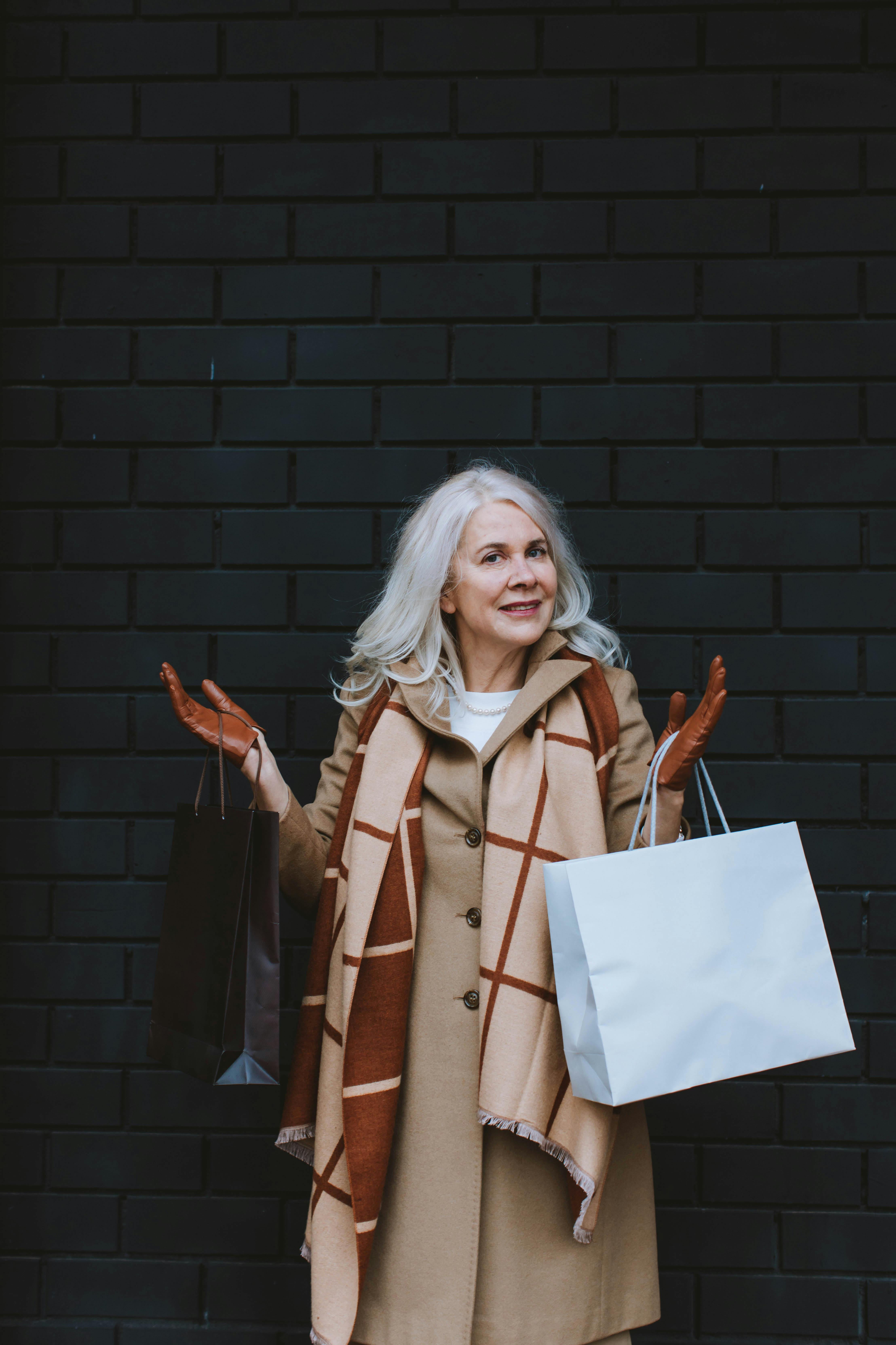 elderly woman carrying shopping bags