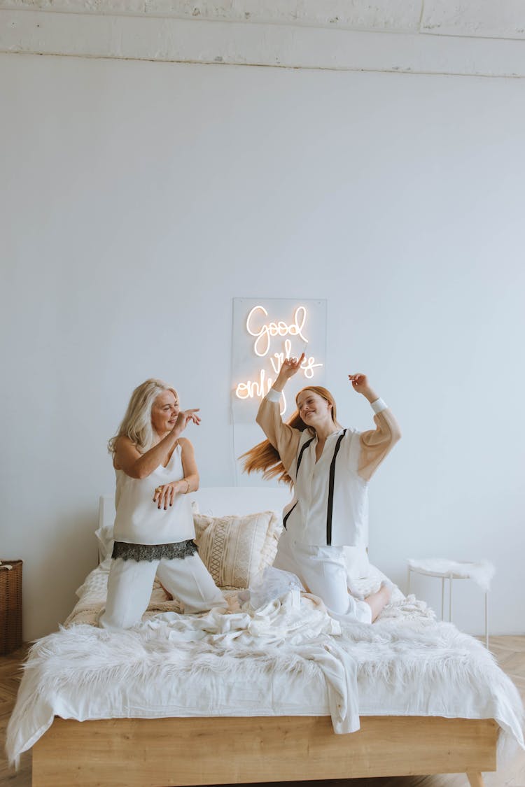 Women Dancing On The Bed