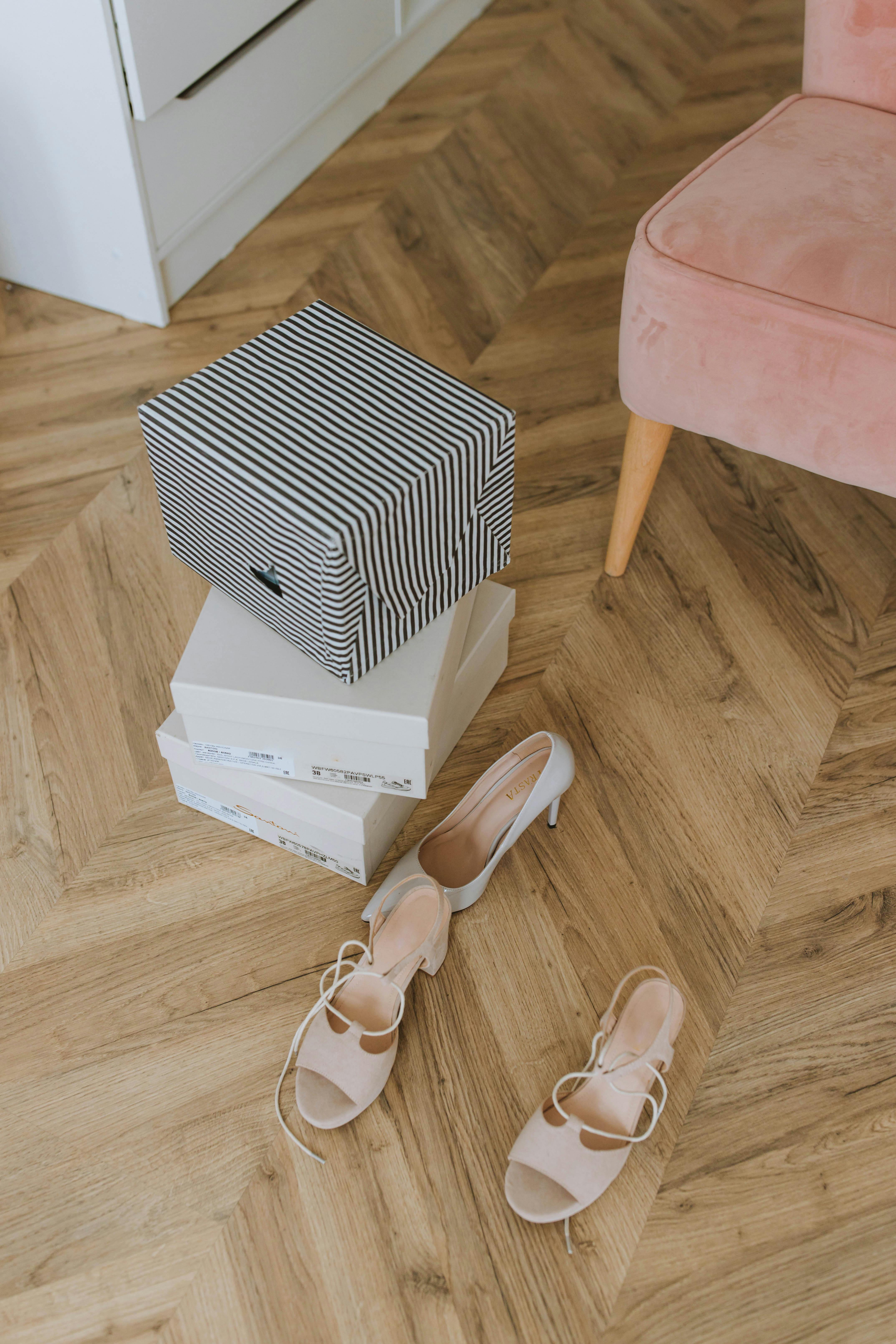 white and black striped box on brown wooden floor