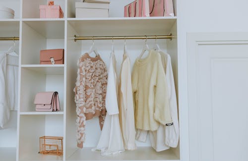 White Long Sleeve Shirt on White Wooden Shelf