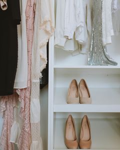 Elegant wardrobe showcasing luxury fashion with beige shoes and delicate clothing.