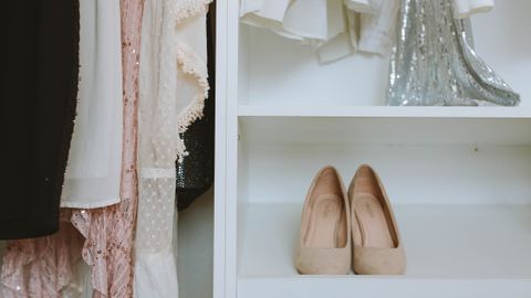 Elegant wardrobe showcasing luxury fashion with beige shoes and delicate clothing.