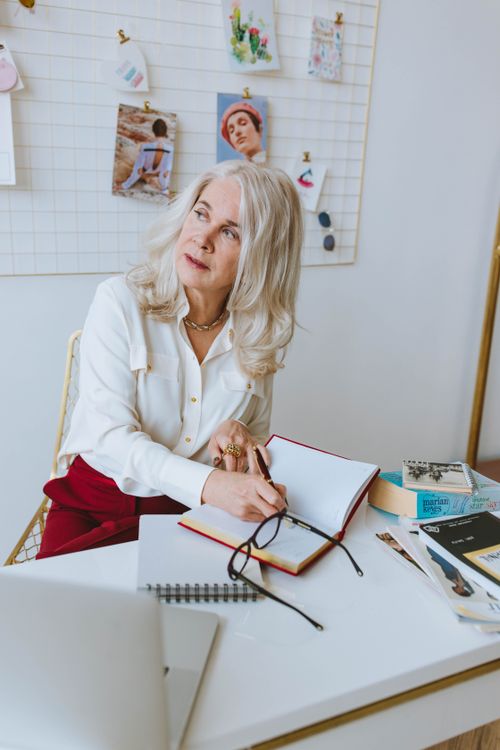 Free Senior woman in work environment, journaling and reflecting. Empowerment in later years. Stock Photo