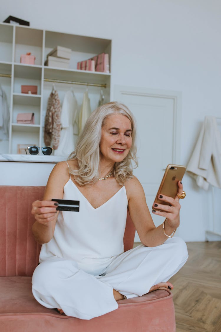 Elderly Woman Holding Cellphone And A Card