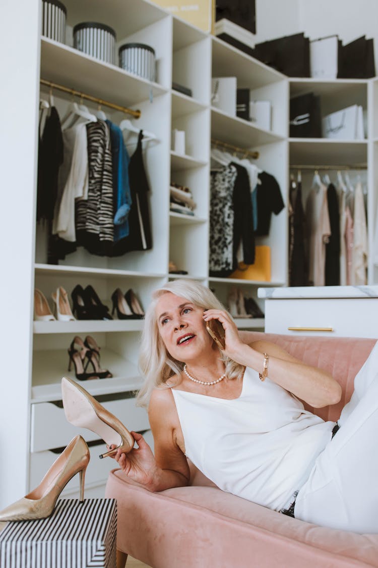 Woman In White Tank Top Sitting On Couch