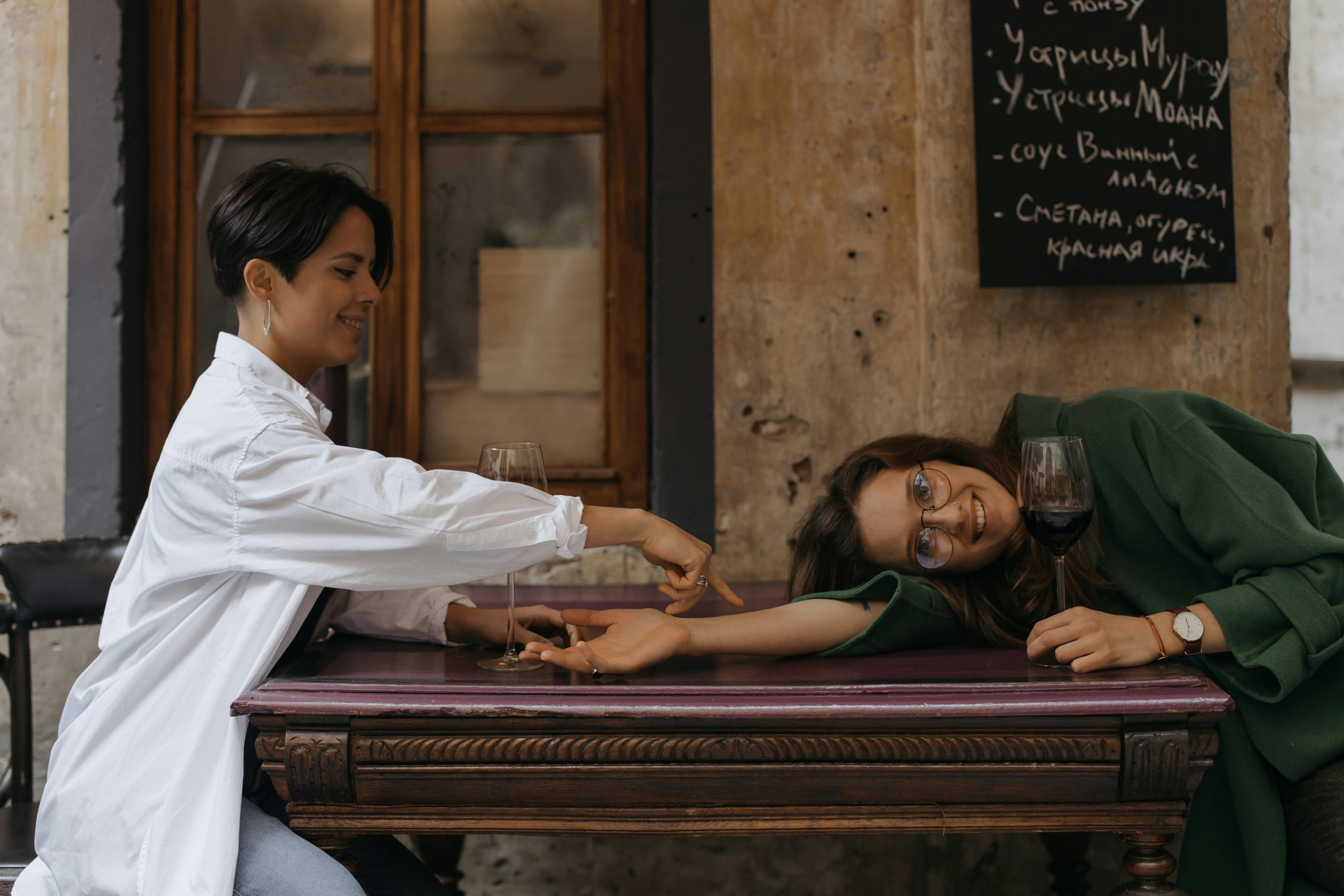 woman in white long sleeve shirt sitting on brown wooden bench