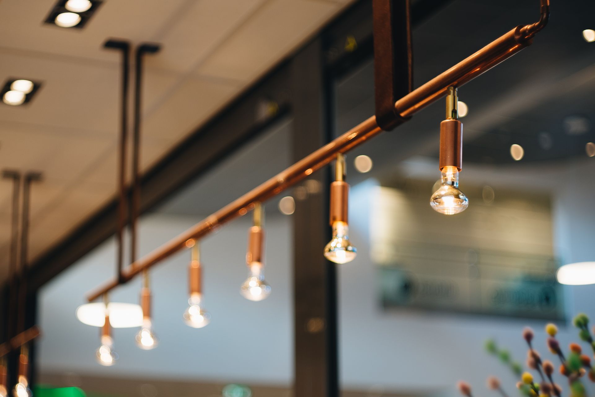 Close-up of elegant modern hanging lights in an interior setting with a focus on design elements.