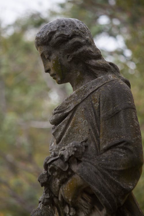 Free Woman Statue in the Graveyard Stock Photo