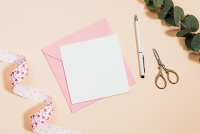 Blank card with a pink envelope, ribbon and scissors — photo by Kaboompics on Pexels