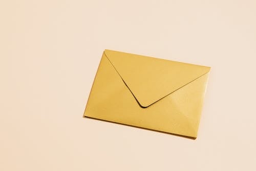 Free Brown Envelope on White Surface Stock Photo