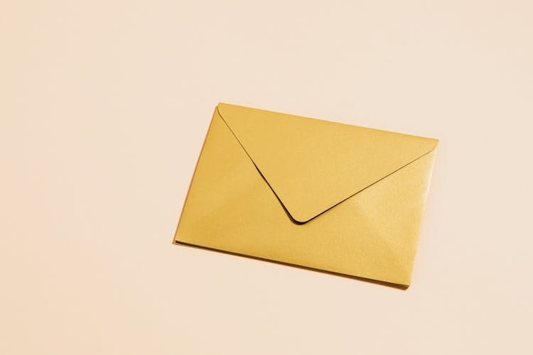 Closed Envelope On Yellow Background