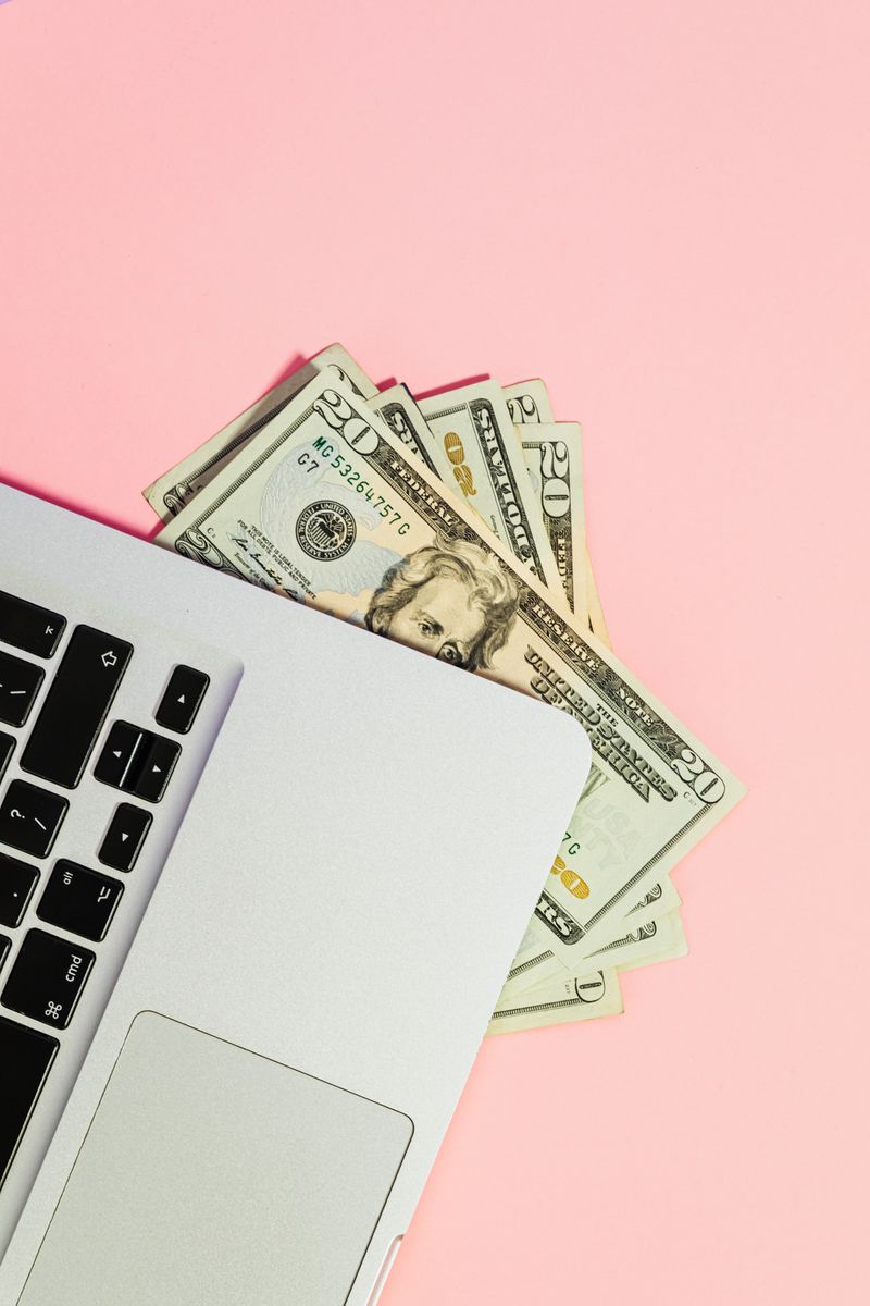 Dollar bills with laptop representing affiliate commission income from organic AI traffic