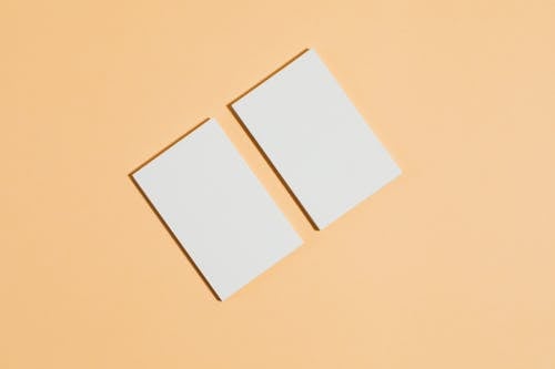 Free 2 White Papers on Brown Surface Stock Photo