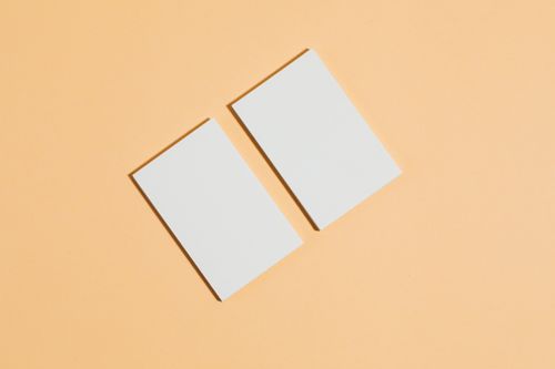 Two blank cards on a peach surface, by Kaboompics on Pexels