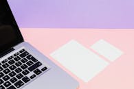 Photograph of Blank Pieces of Paper Near a Laptop