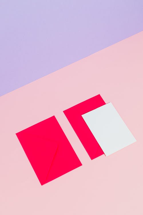 Photograph of a Piece of White Paper on a Bright Pink Paper