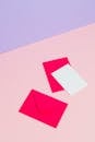 Photo of a White Card Near a Pink Envelope