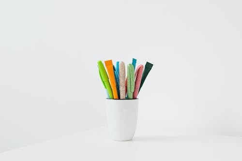Free White Ceramic Cup With Colorful Pens Stock Photo