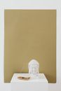 White Buddha Figurine on White Table
