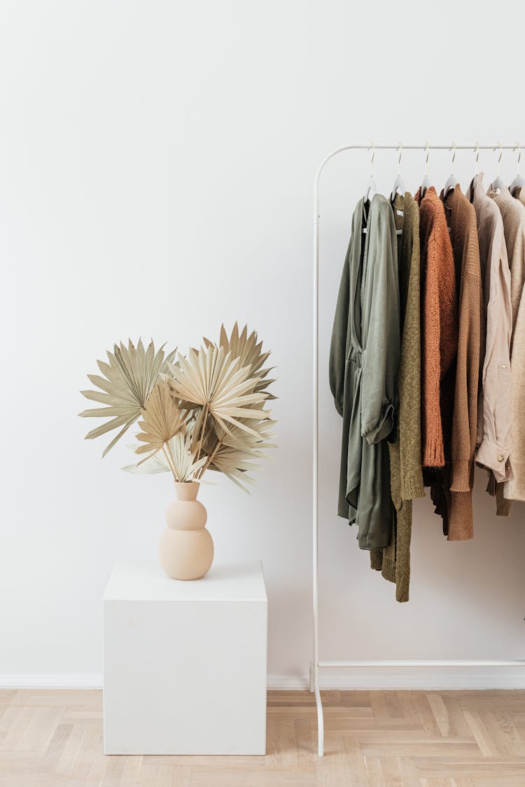 Knitted Cardigans Hanging On Clothes Rack 