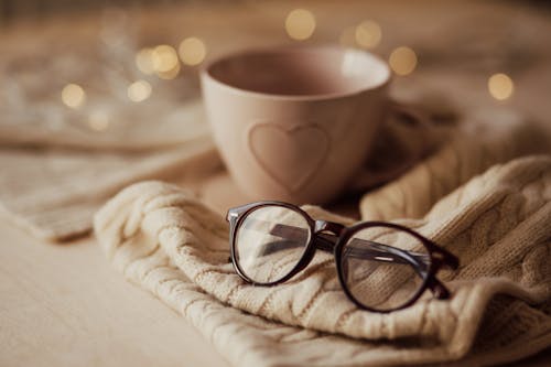 Free Eyeglasses with mug on warm scarf Stock Photo